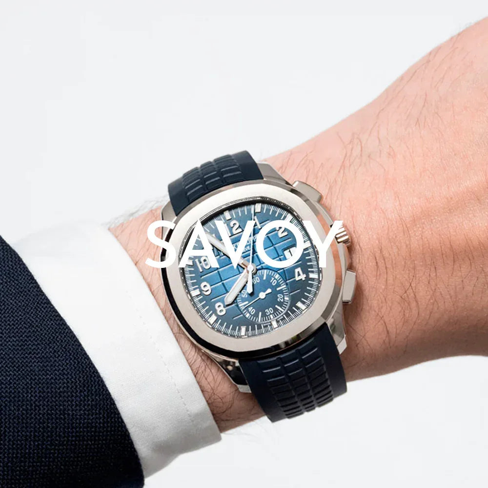 Men's luxury watch with blue textured dial and black silicone strap on wrist, elegant style